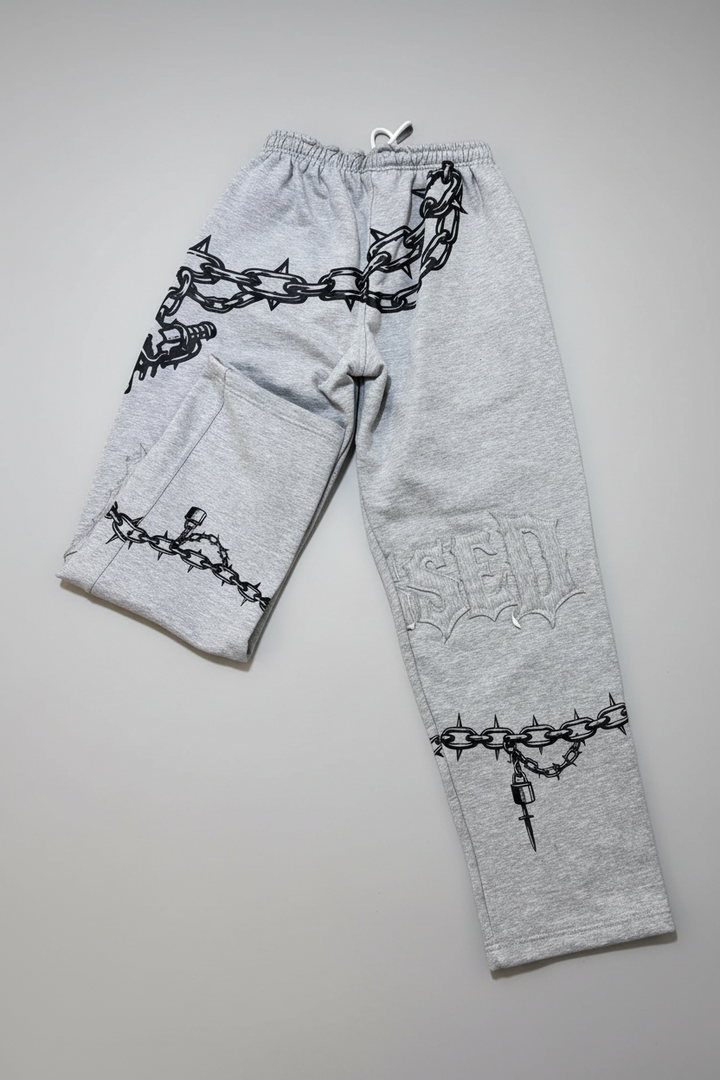 Gray sweatpants with black chain and barbed wire design on a white background