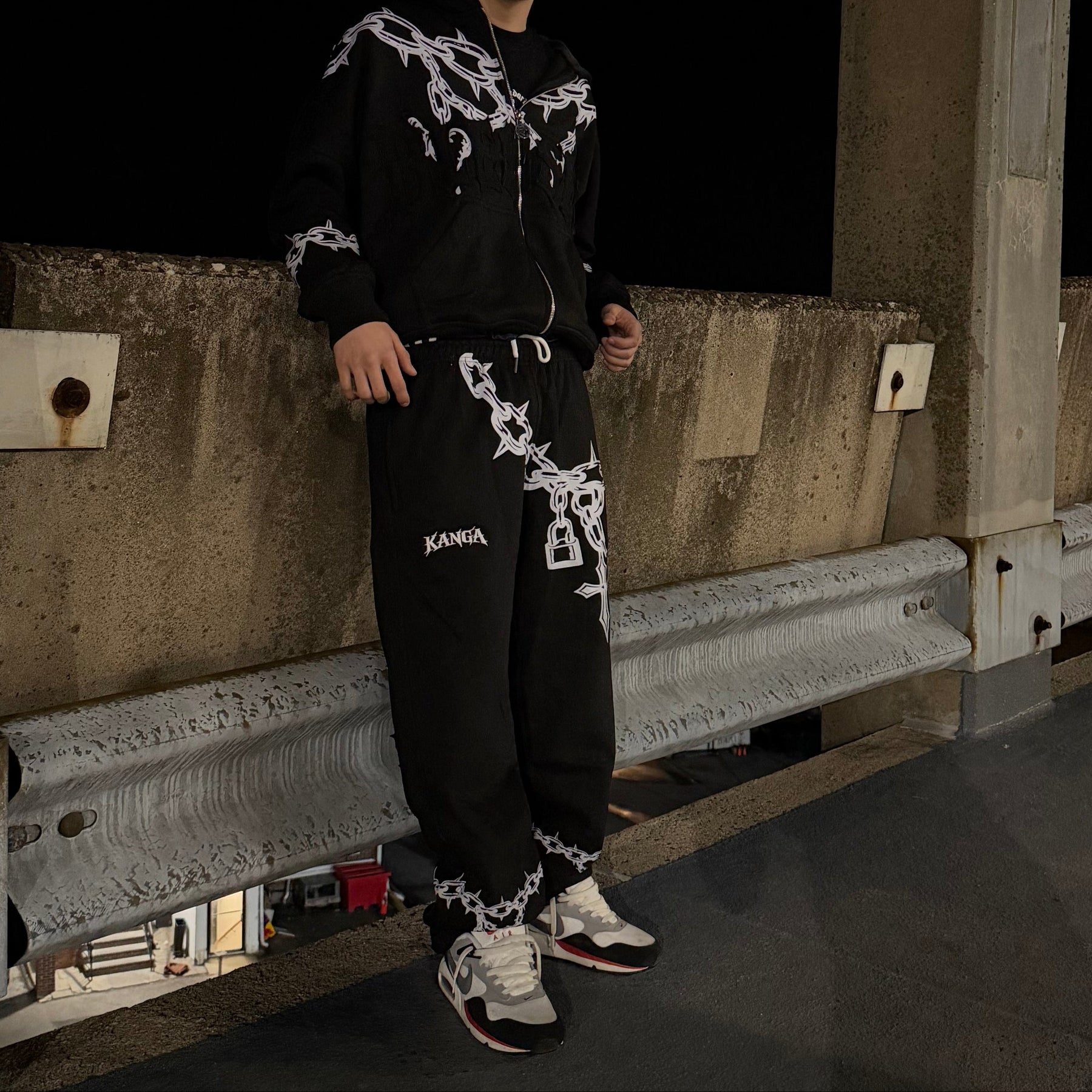 Person standing on a concrete surface with a dark background