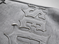 Close-up of a textured surface with embossed lettering on a gray background