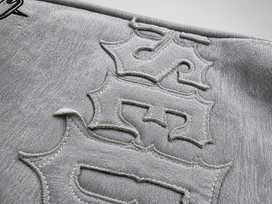 Close-up of a textured surface with embossed lettering on a gray background