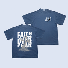Navy blue t-shirt with 'Faith Over Fear' on the front and 'Jesus' on the back against a light blue background