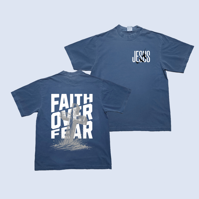 Navy blue t-shirt with 'Faith Over Fear' on the front and 'Jesus' on the back against a light blue background