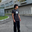Young boy standing on a paved area in front of a building